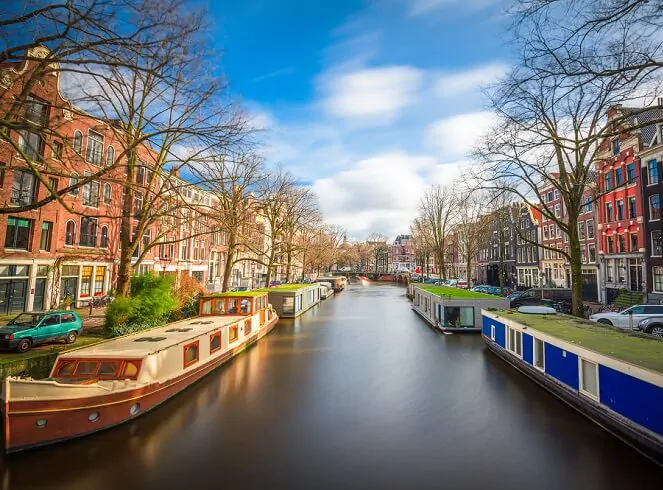 canal with boats in it and houses either side