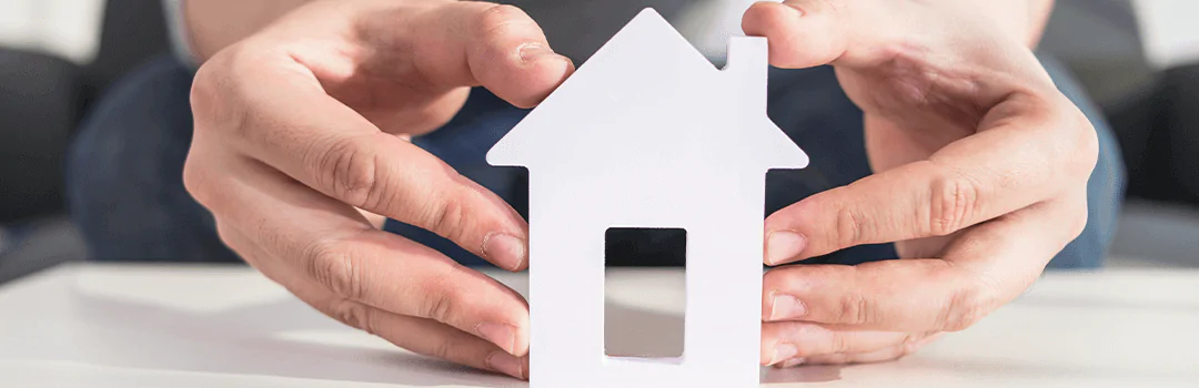 Man holding a white block house in his hands