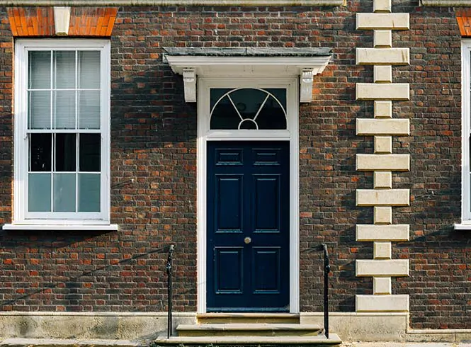 black front door with brown bricks