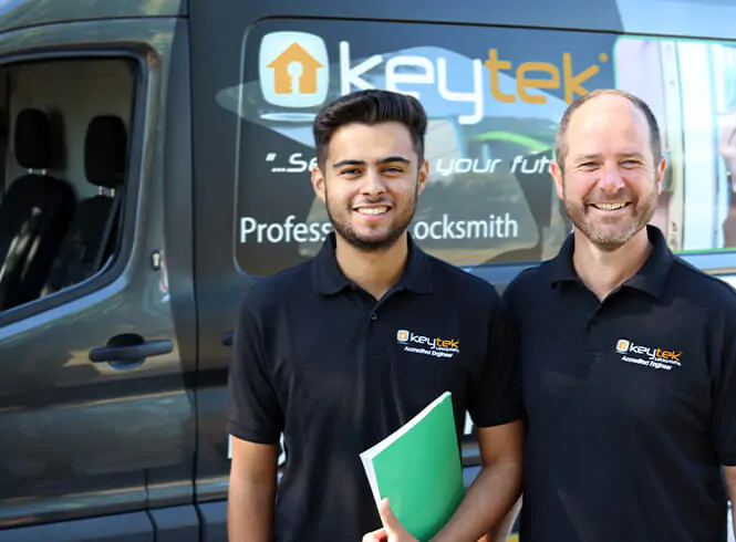 two locksmiths standing outside their van