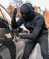 thief trying to break in and steal car