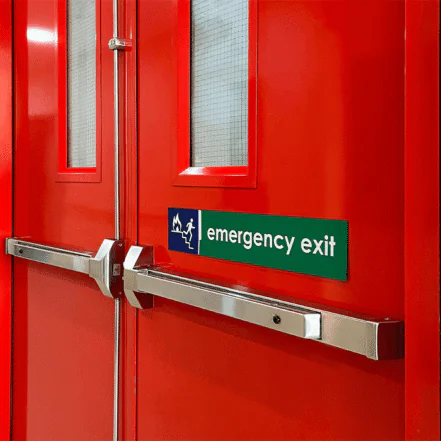 Red emergency exit doors featuring a green sign with white text and symbols indicating the escape route in case of an emergency.