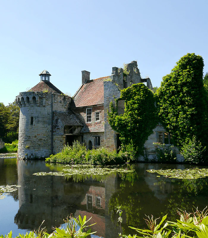 grey concrete building near green trees and body of water during daytime