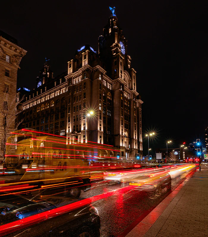 a city street filled with lots of traffic at night
