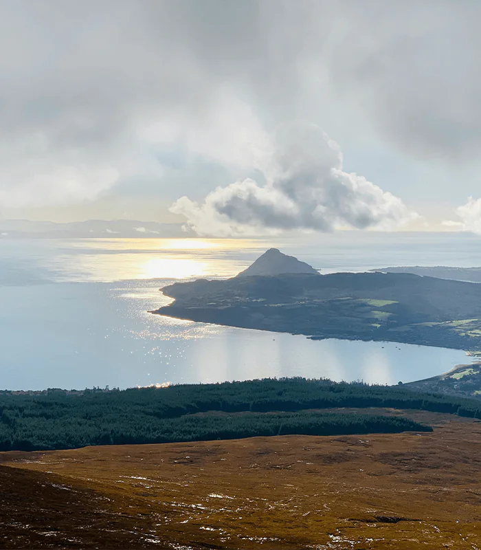 A view of the Holy Isle through cloud cover from the top of Goat Fell, Isle of Arran, UK