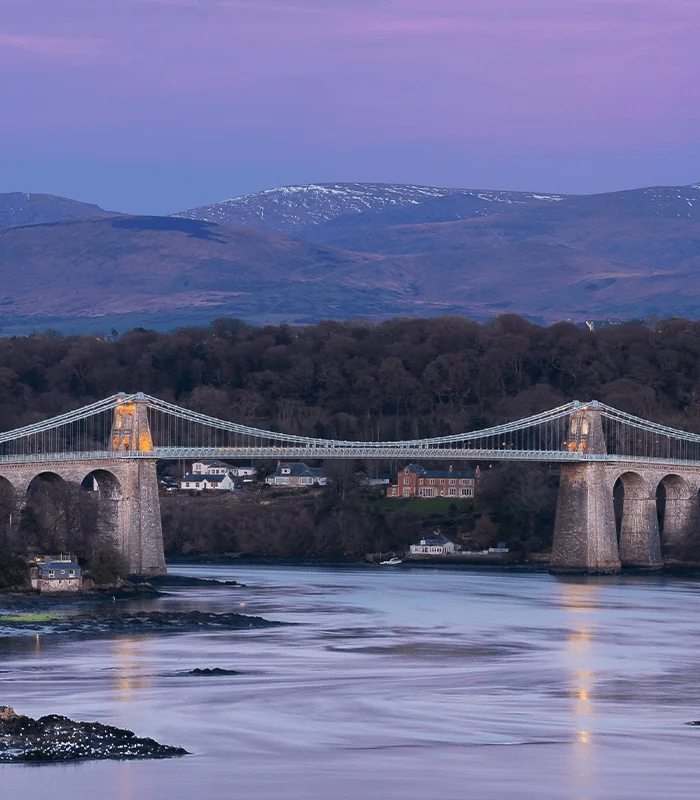 landscape photography of cable bridge near mountain range