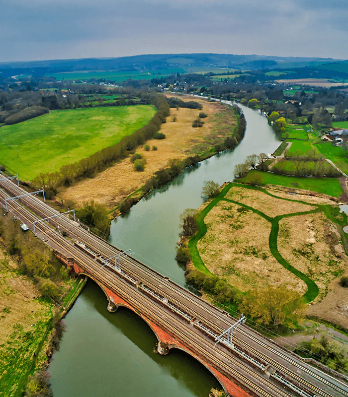 bridge over the river under grey cloudy sky