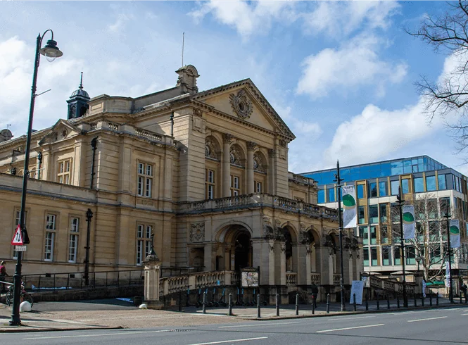 a large building with a clock on the top of it. Cheltenham city hall